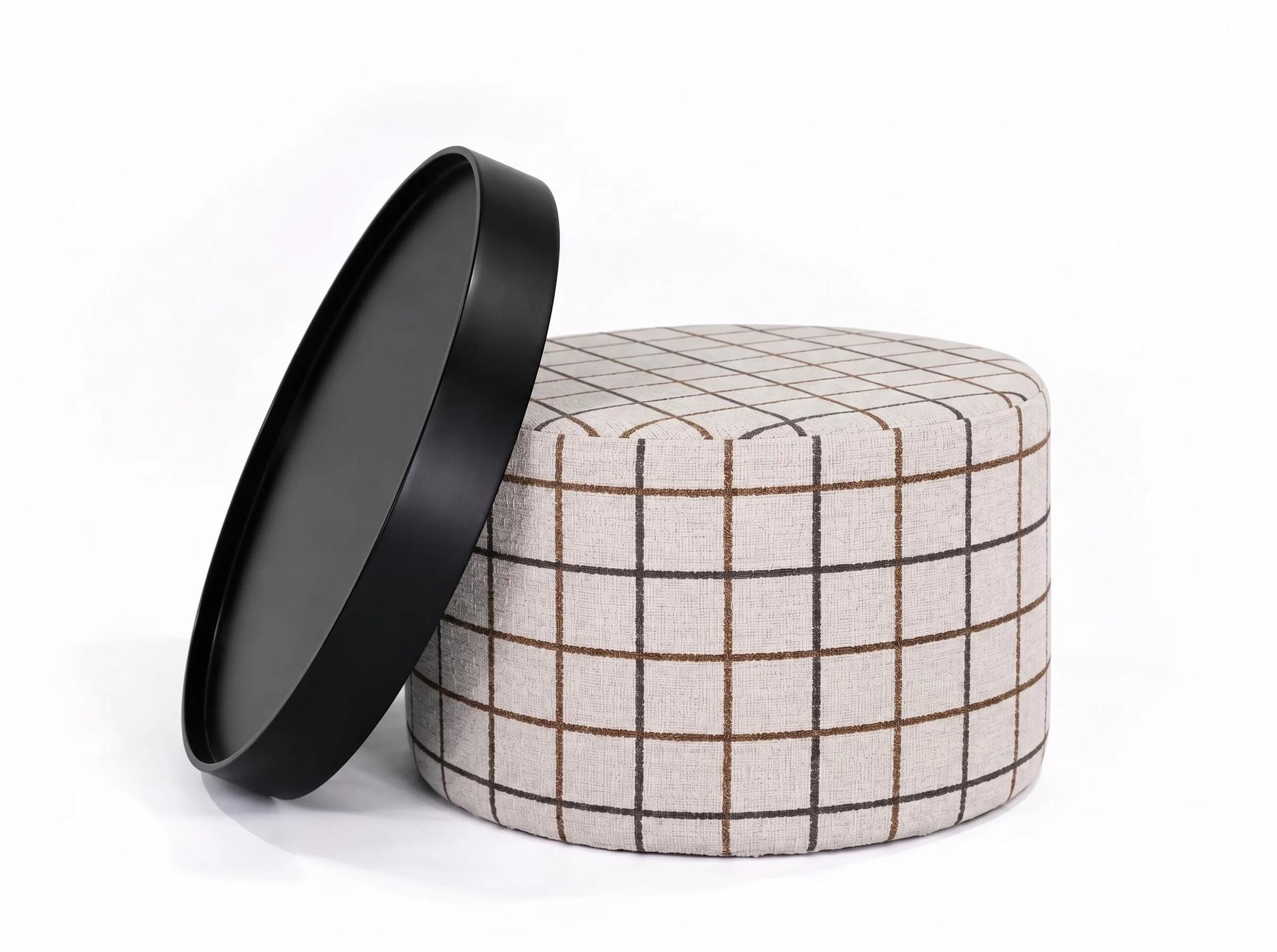 Perge Pouf, round body in cream check fabric with a black tray lid, white background